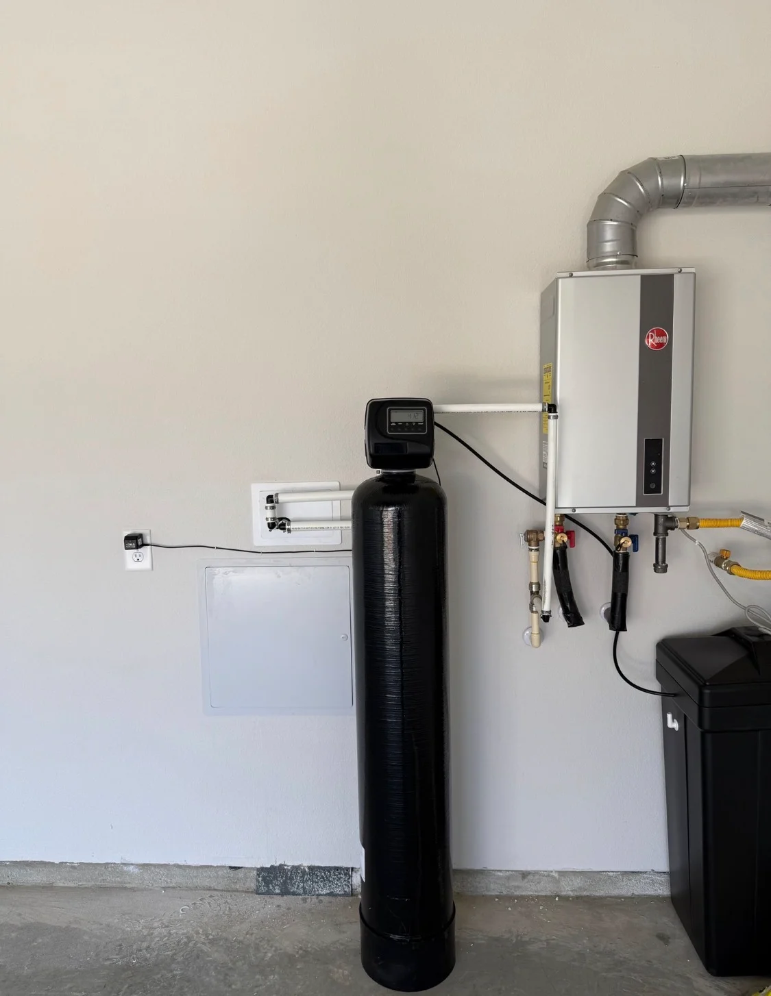 Installed whole-home water filtration system with softener tank and Rheem tankless heater Installed whole-home water filtration system with softener tank and Rheem tankless heater